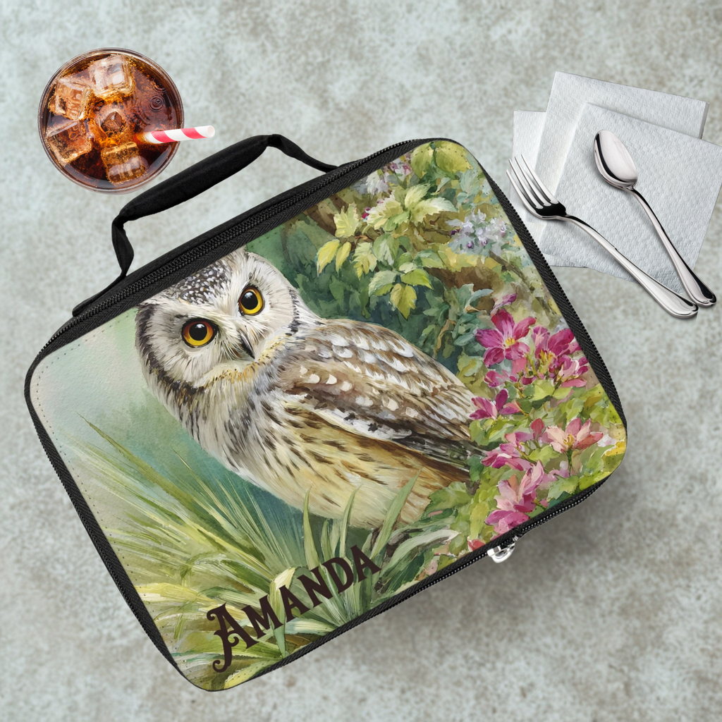 Lunch bag with owl design and 'AMANDA' personalized text on a cafeteria table with a drink and utensils.