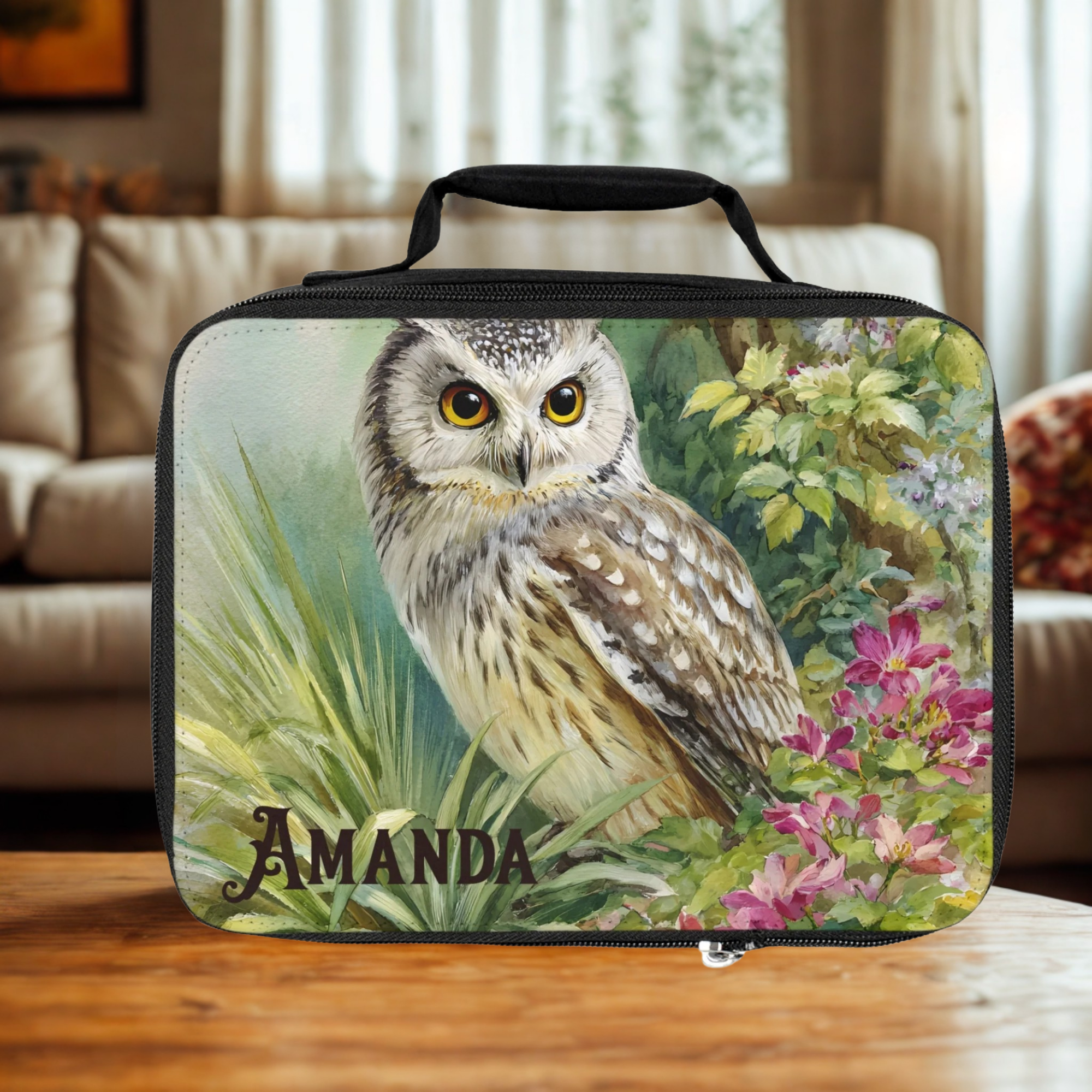  insulated lunch bag with owl design and 'Amanda' personalized text on a wooden living room table.