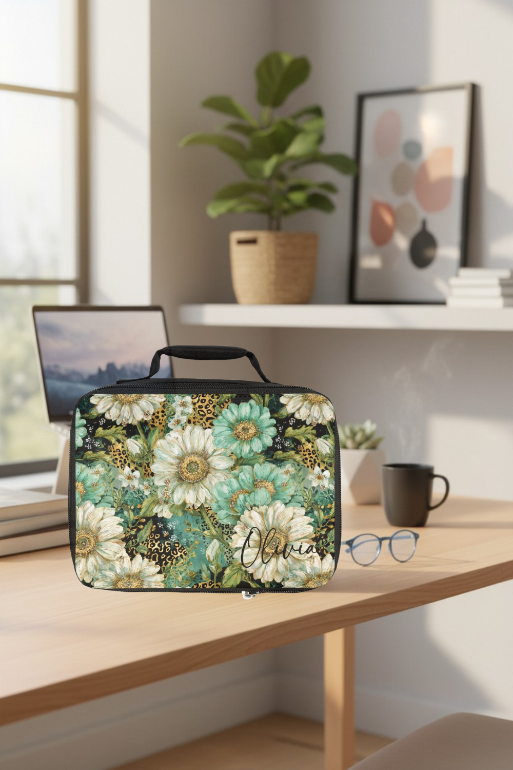 Floral-patterned lunch bag on a desk with a laptop, mug, and glasses in a cozy office.