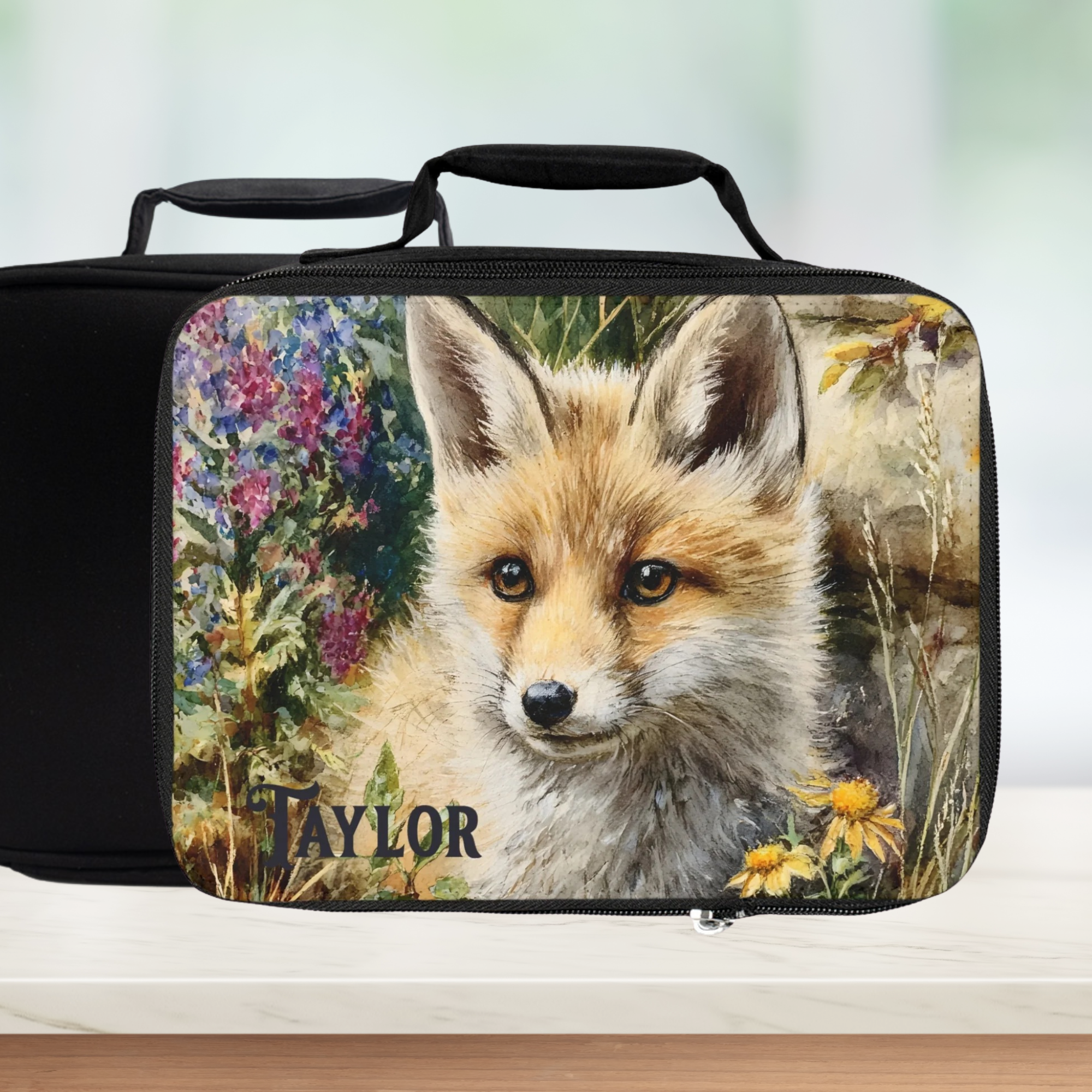 Black lunch bag with a fox design and 'Taylor' text on a white background