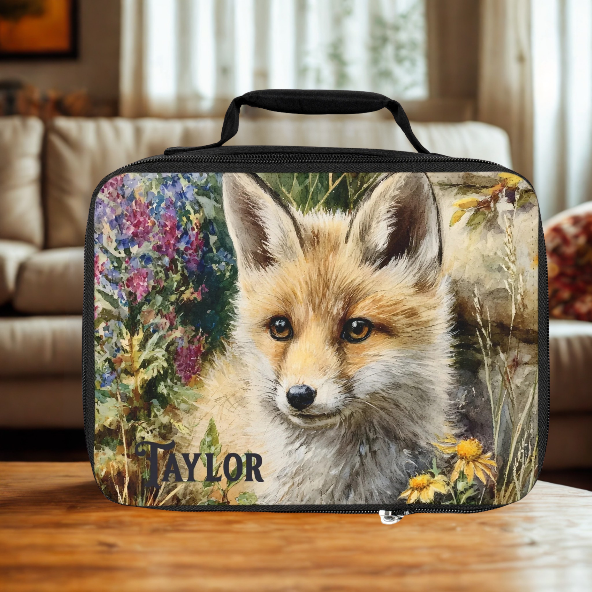  insulated lunch bag with a fox design and 'Taylor' text on a wooden living room table