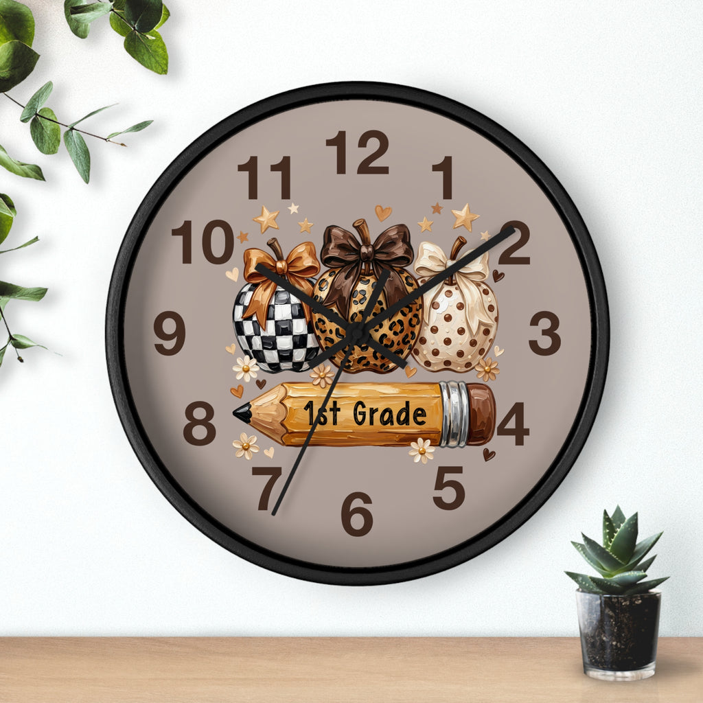 Decorative wall clock with pumpkins and a pencil on a neutral background