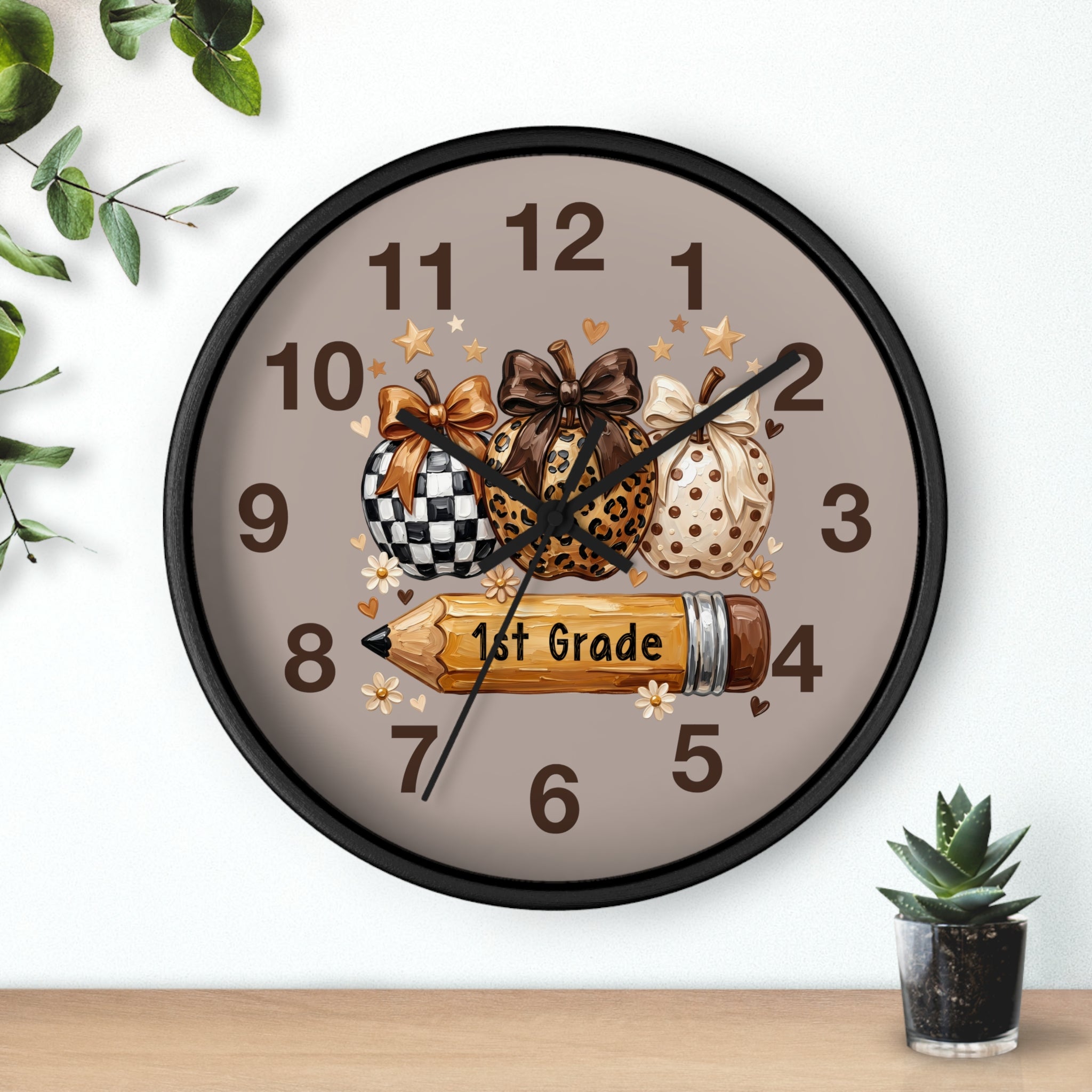 Decorative wall clock with pumpkins and a pencil on a neutral background