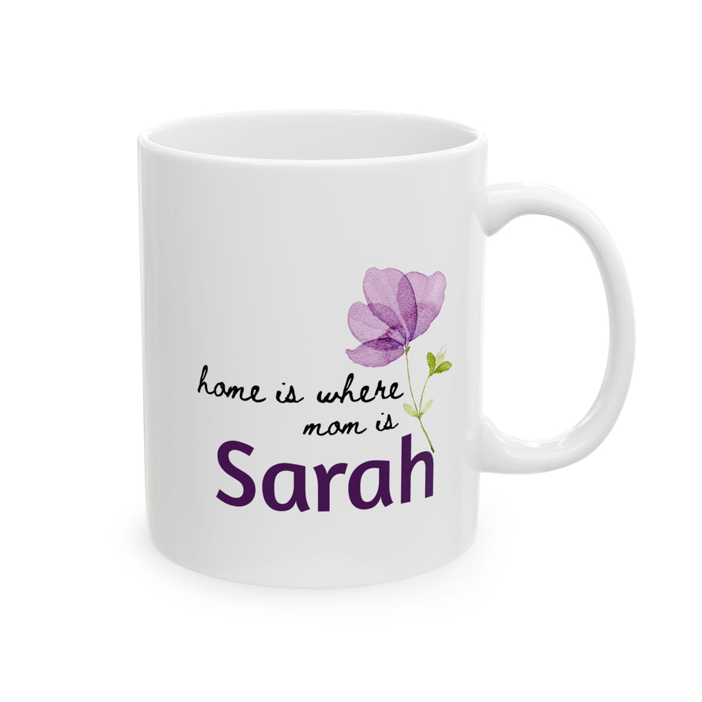 White mug with purple flower and text 'home is where mom is Sarah' on a white background
