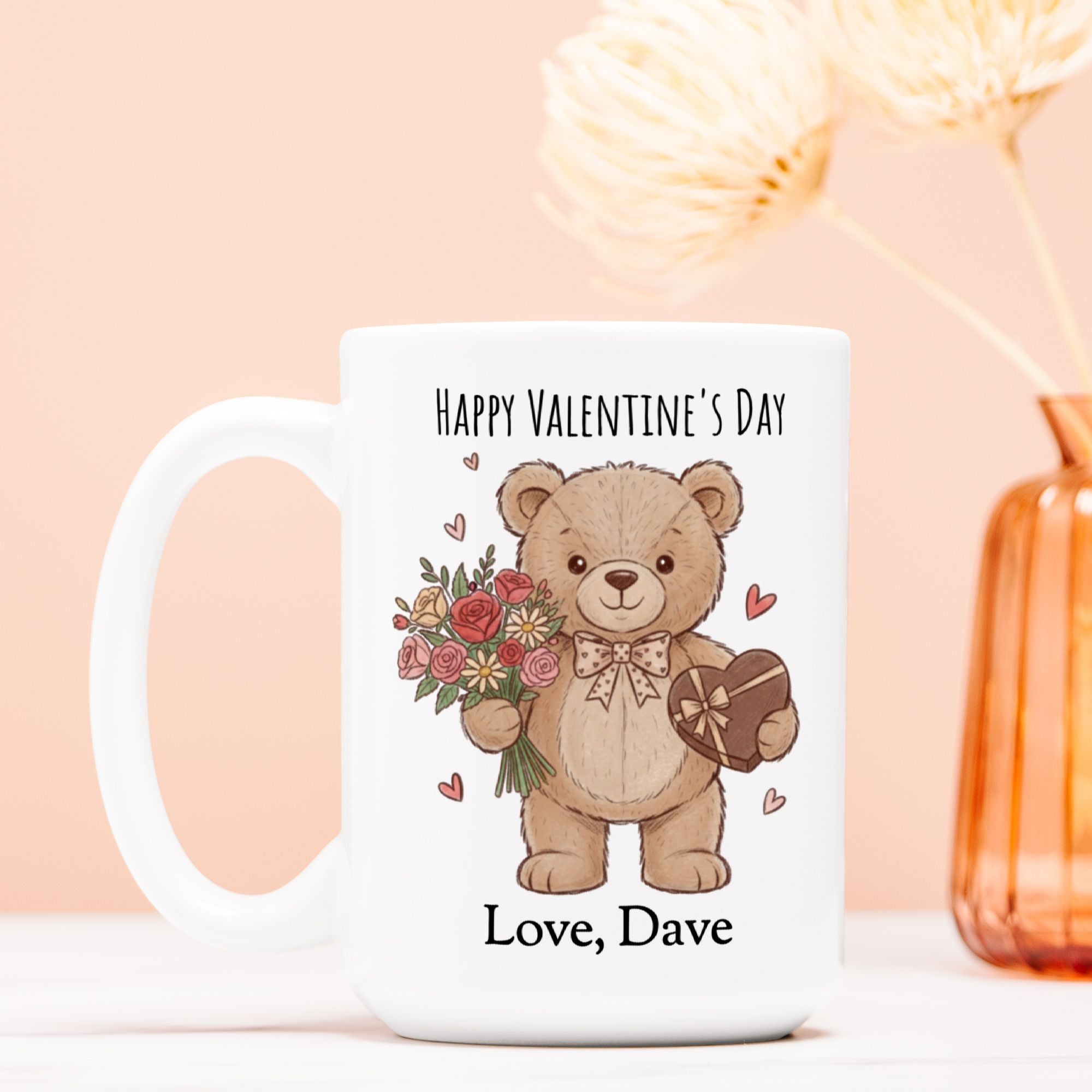 Valentine's Day mug with a teddy bear holding flowers and a heart, on a light pink background.