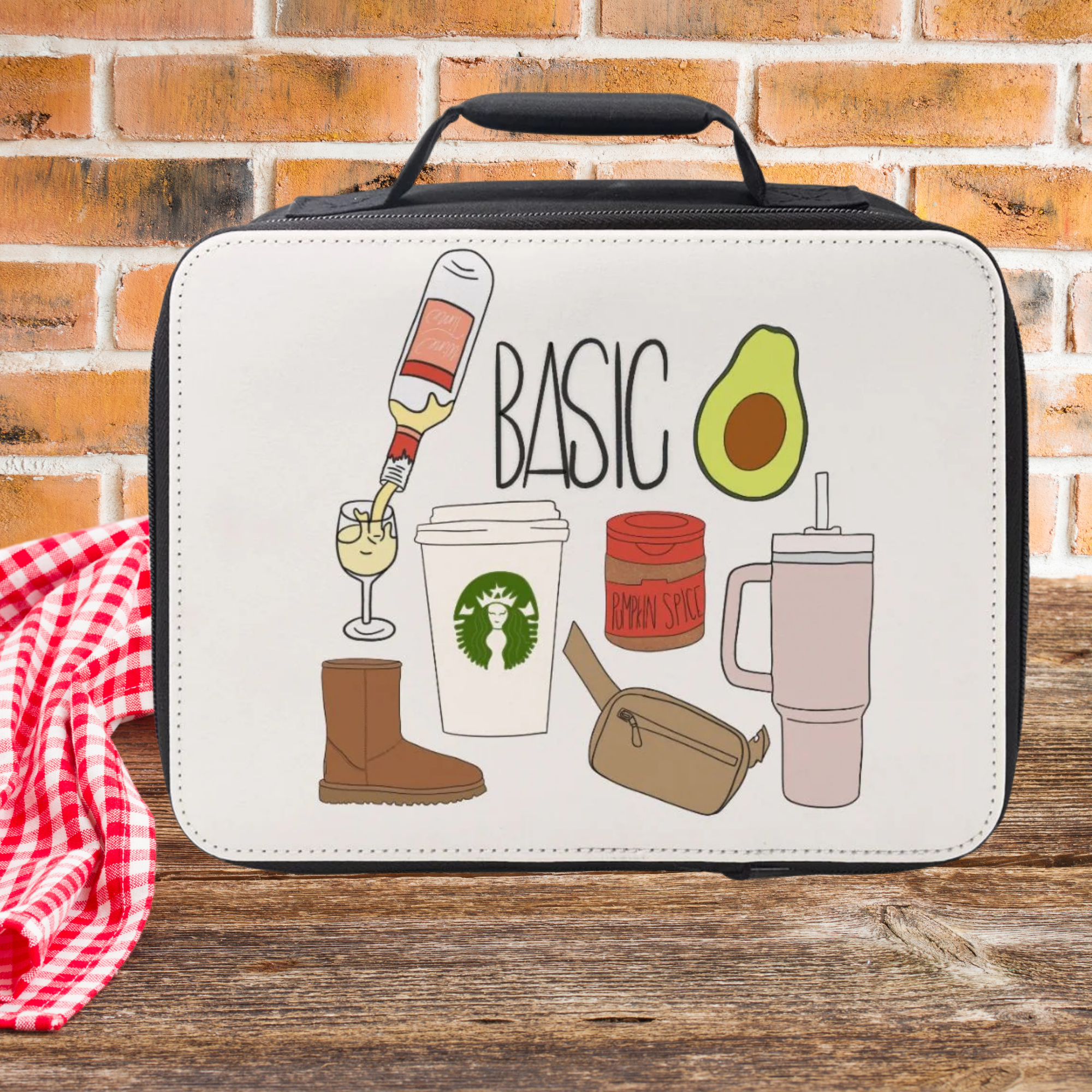 White lunch bag with illustrations and text on a wooden picnic table with a brick wall background