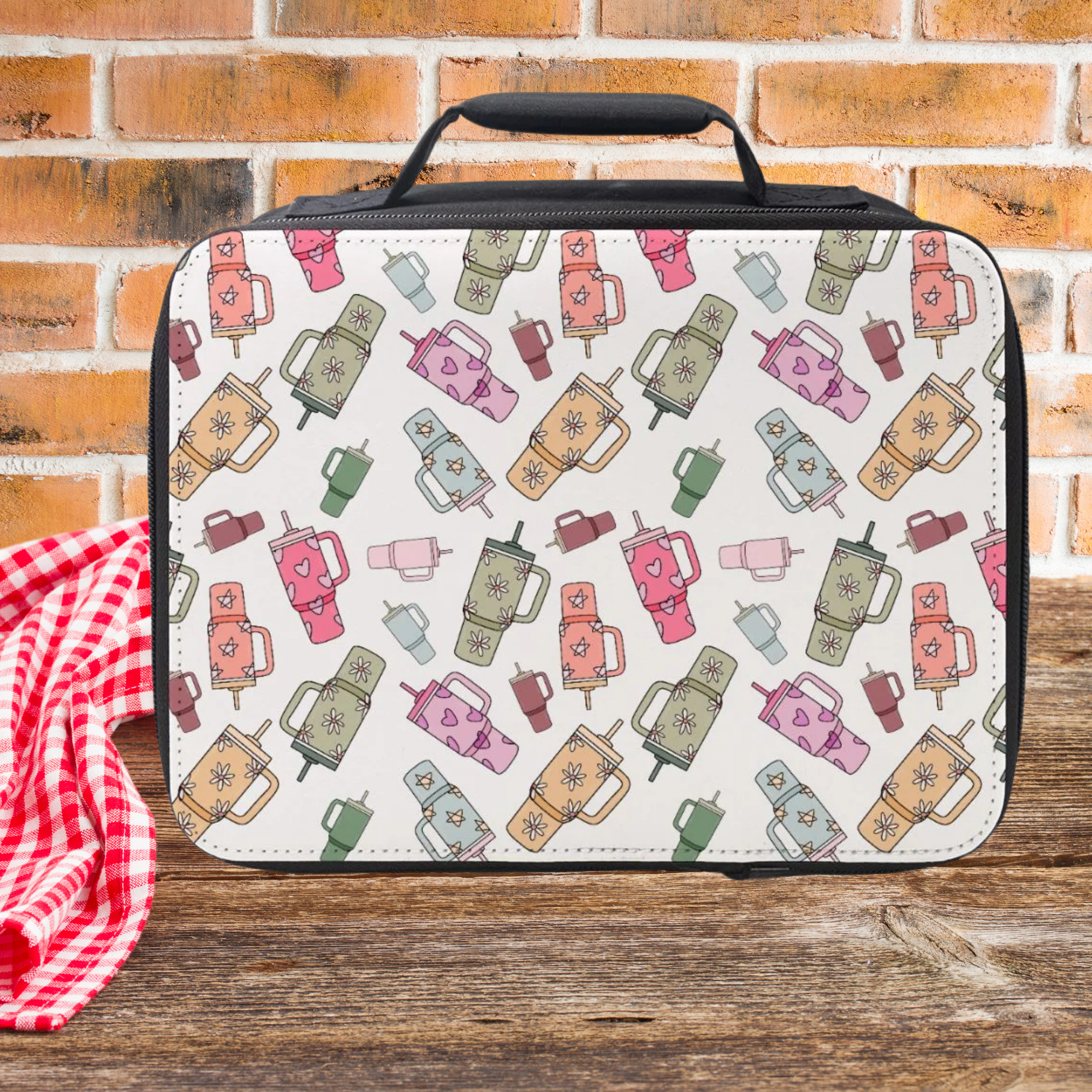 Lunch box with colorful thermos pattern on a wooden surface and brick wall background