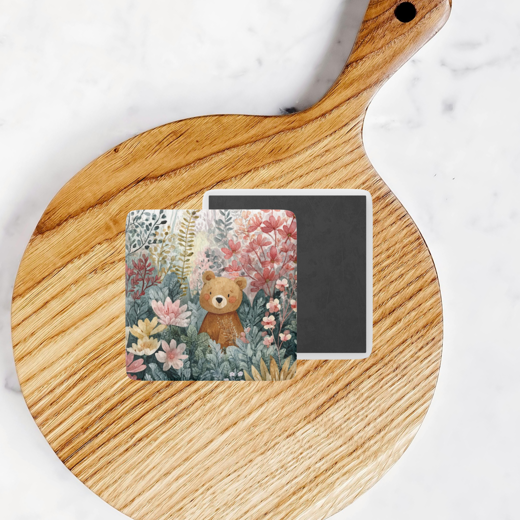 Square card with a bear and floral design on a wooden board