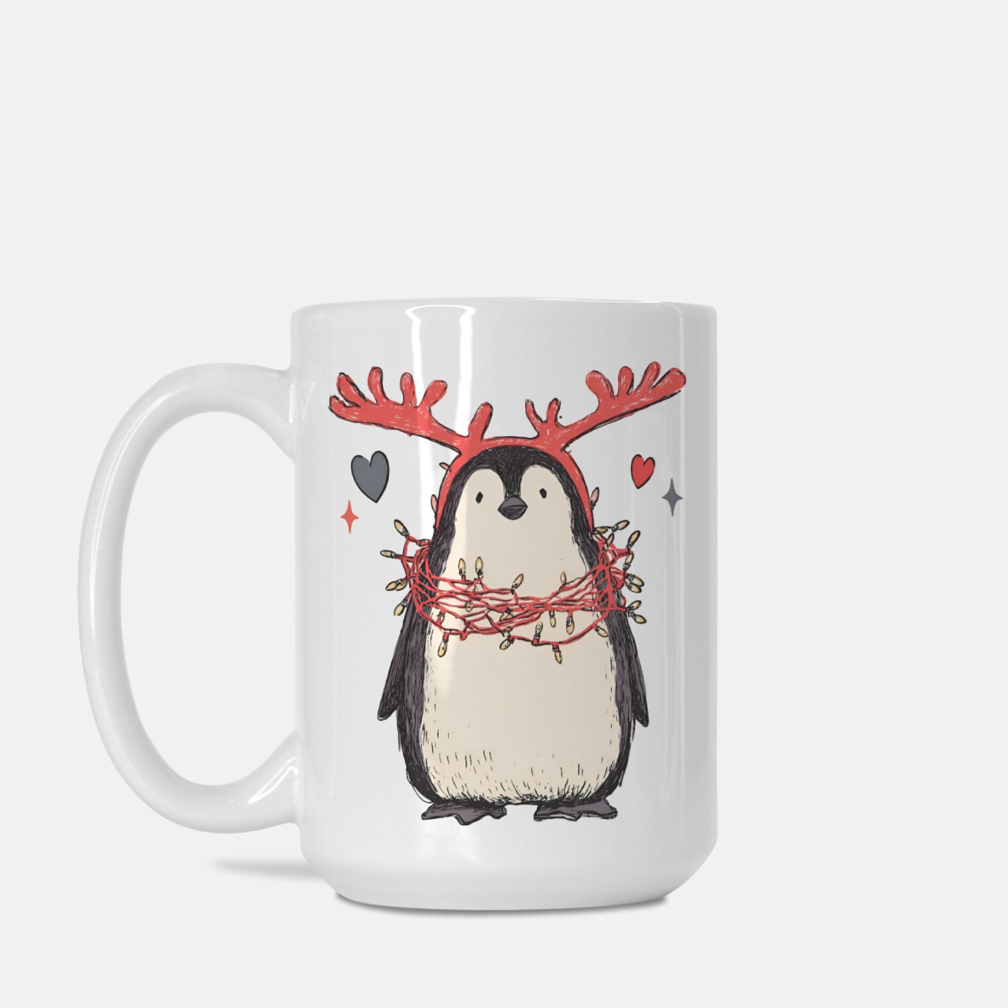 White mug with a penguin wearing reindeer antlers and a wreath design on a white background
