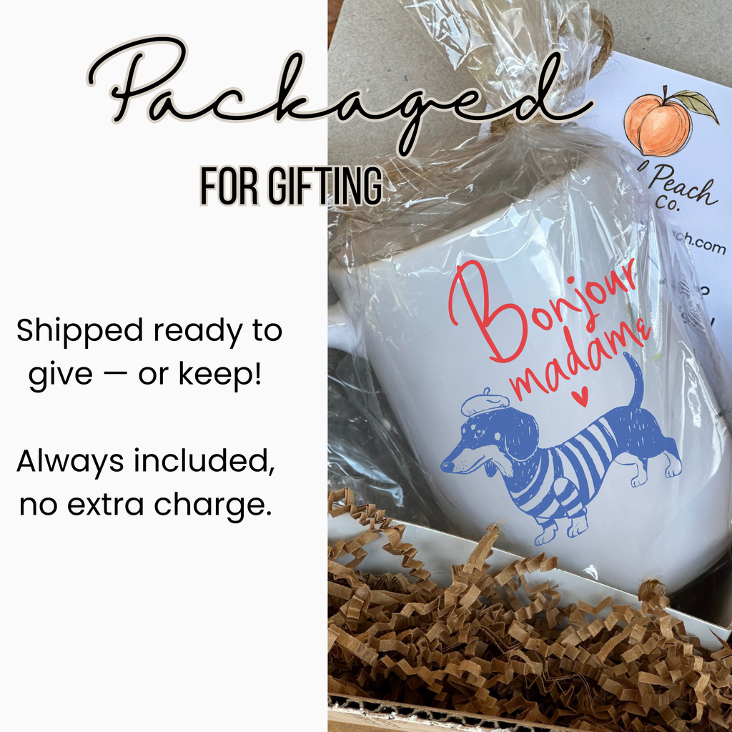 White 15oz. mug with a dachshund illustration and text 'Bonjour madame' in a gift-wrapped box.