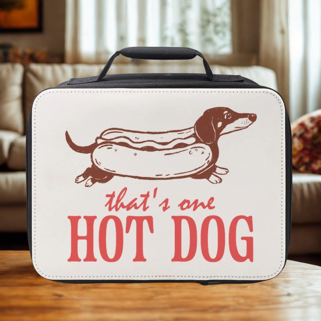 Insulated lunch bag with Dachshund as a hot dog illustration and text on a wooden living room table