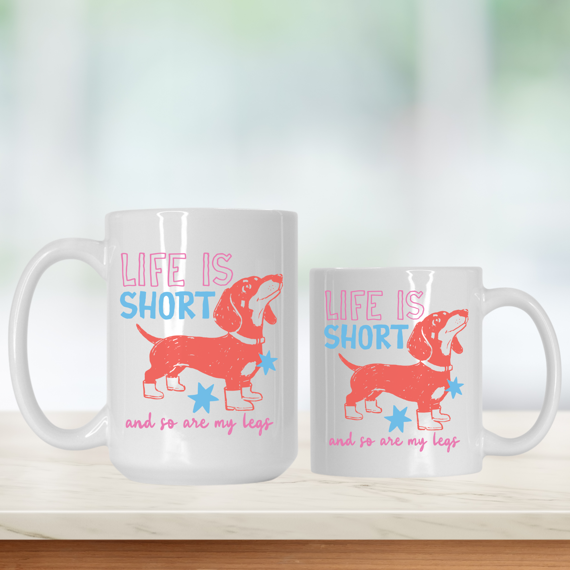 Two white mugs with a dachshund design and text on a light background