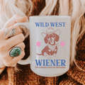 Person holding a 15oz. mug with 'Wild West Wiener' design featuring a dachshund illustration.