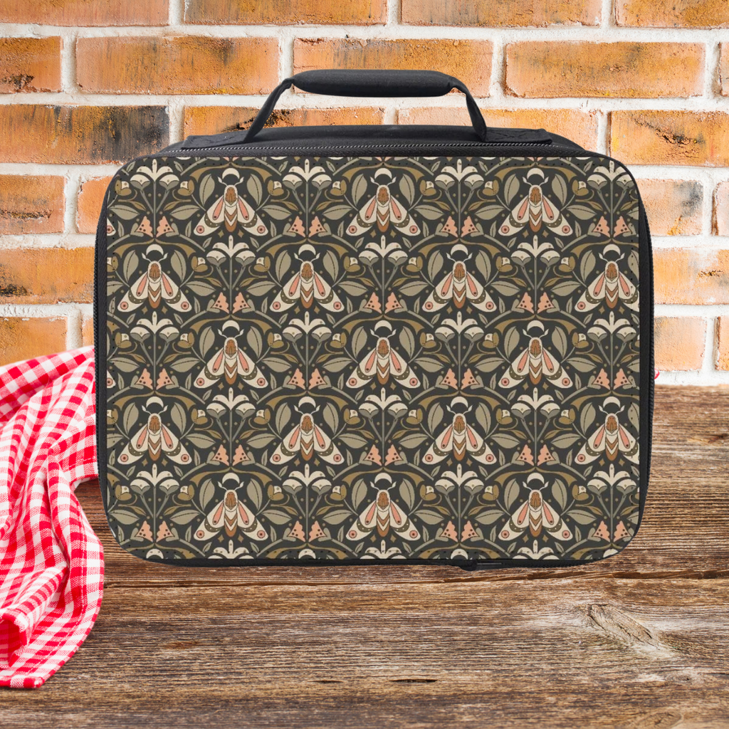 Floral moth patterned lunch bag on a wooden picnic table with a brick wall background