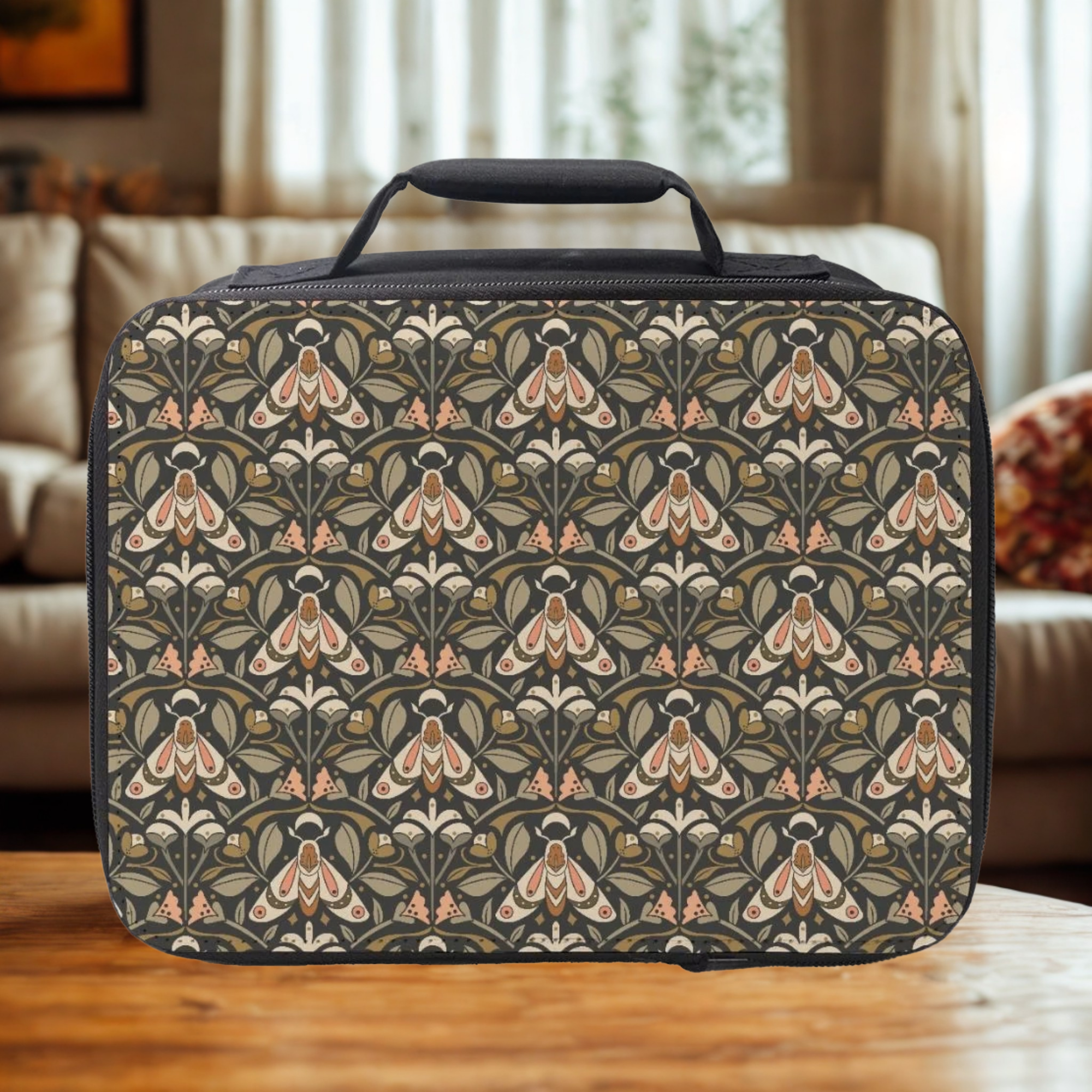 Moth & floral patterned lunch bag on a wooden table with a blurred indoor background