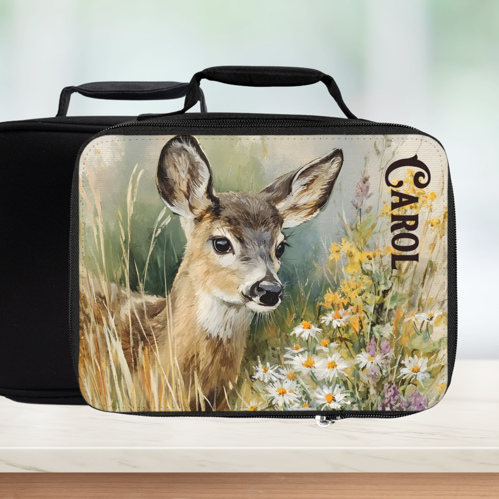  insulated lunch bag with a deer design and 'Carol' custom text on a counter with a blurred green background