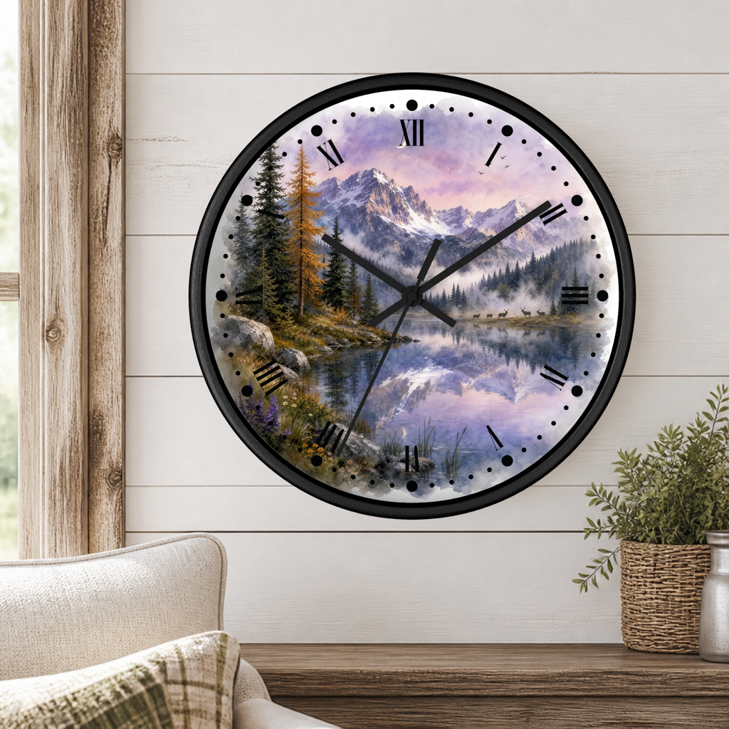 A round wall clock with a black frame and a scenic landscape print of a mountain lake at dusk, mounted on a white shiplap wall above a wooden table with a plant and part of a sofa visible.