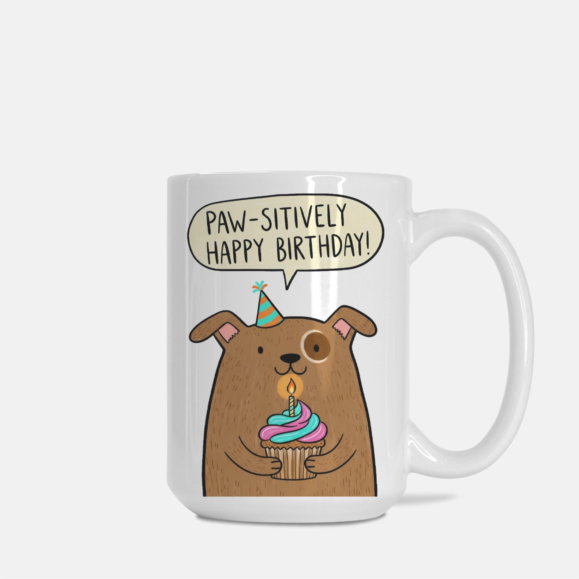 Mug with a cartoon dog holding a birthday cake and a speech bubble saying 'Paw-sitively Happy Birthday!' on a white background.