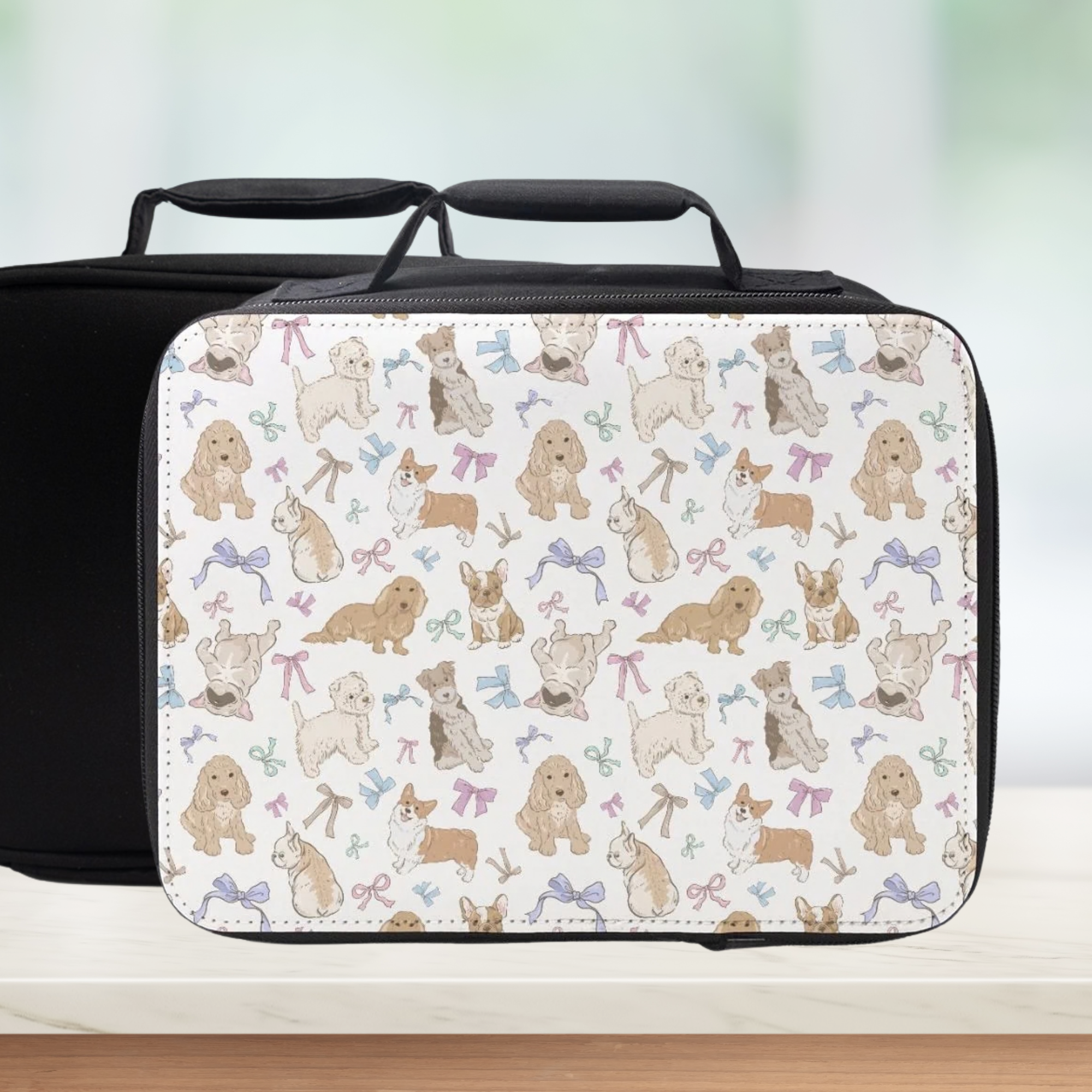Black lunch bag with a pattern of dogs and bows on a light background