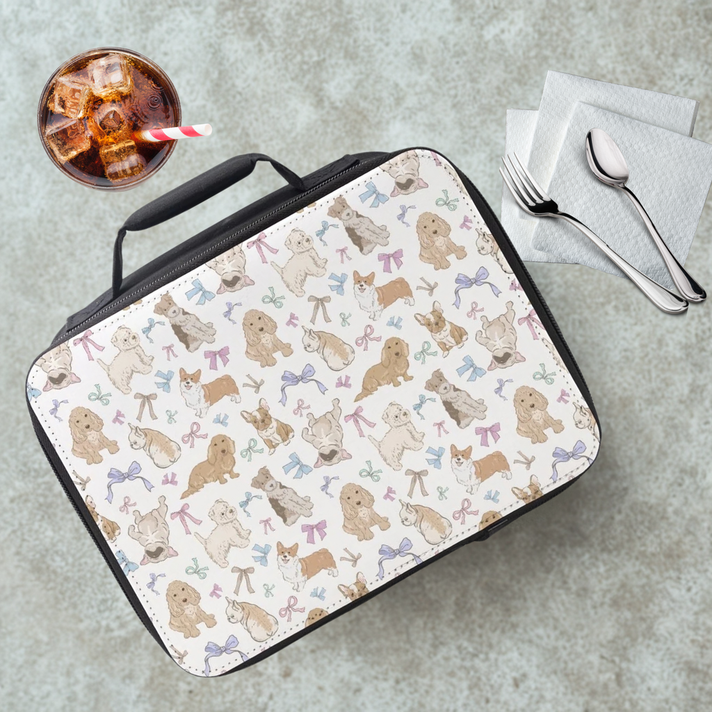 Lunch bag with dog pattern on a cafeteria table with a drink and utensils.