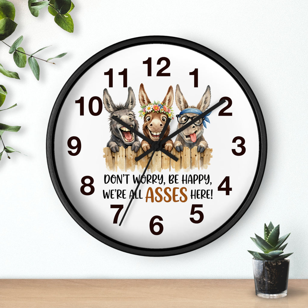 Wall clock with cartoon donkeys and humorous text on a white background