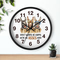 Wall clock with cartoon donkeys and humorous text on a white background