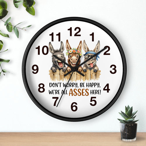 Wall clock with cartoon donkeys and humorous text on a white background