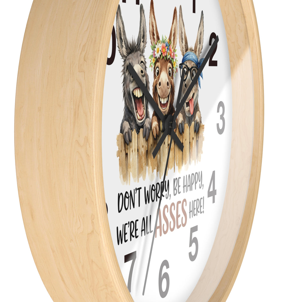 Wall clock with cartoon donkeys and humorous text on a white background
