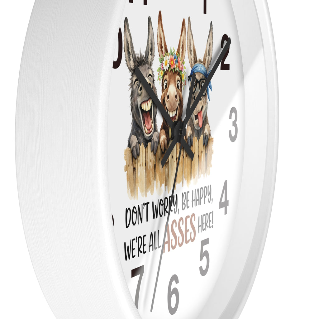 Wall clock with cartoon donkeys and humorous text on a white background