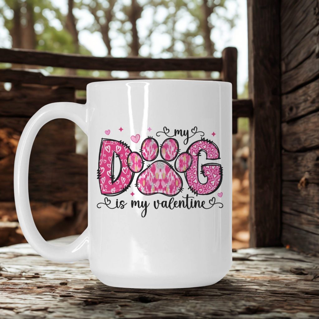 White mug with pink paw print design and text on a wooden surface