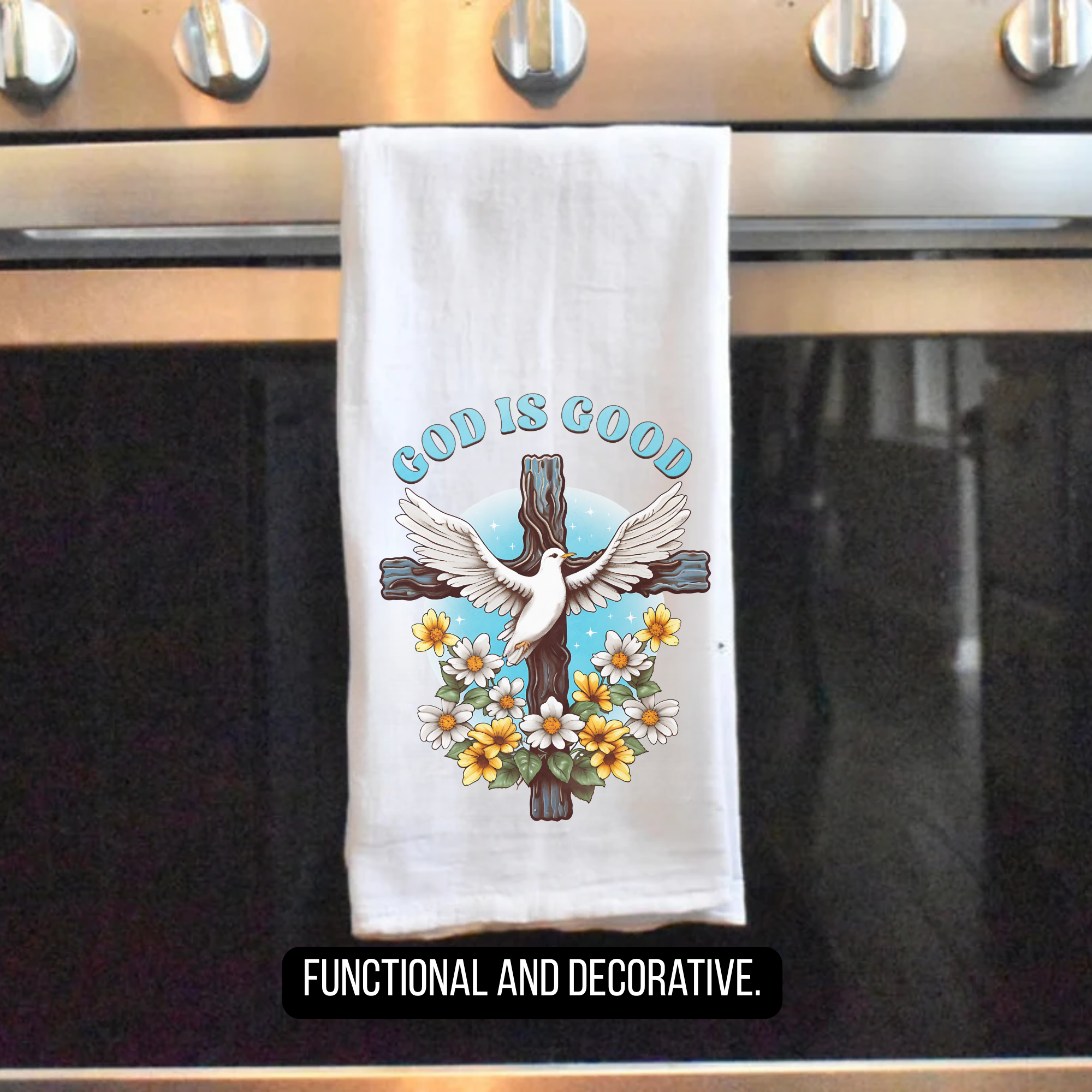 Decorative tea towel with 'God is Good' text hanging on a stove.