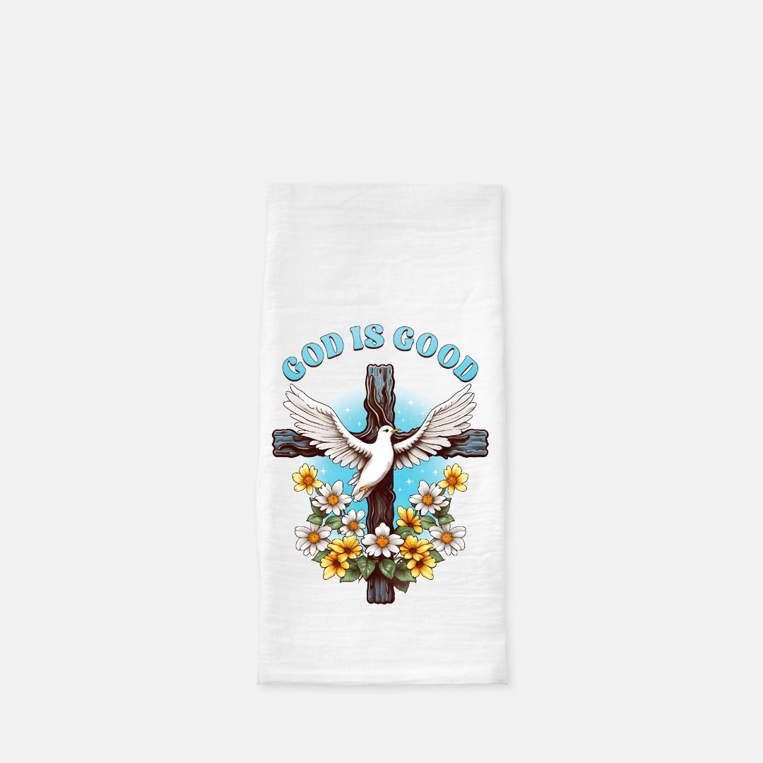 Folded white tea towel with a cross, dove, and 'God is Good' text on a white background