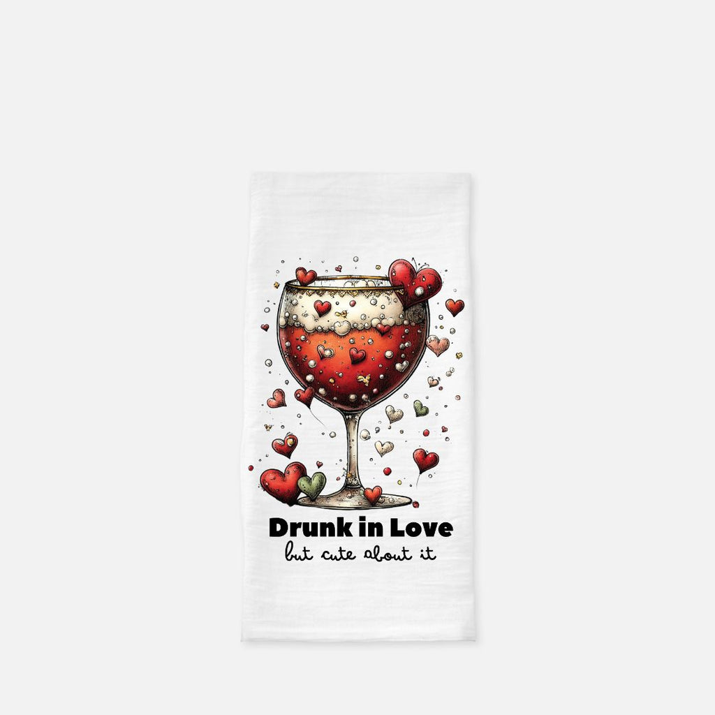 Tea towel with a wine glass design and text 'Drunk in Love but cute about it' on a white background