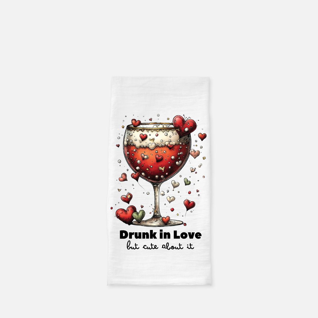 Tea towel with a wine glass design and text 'Drunk in Love but cute about it' on a white background