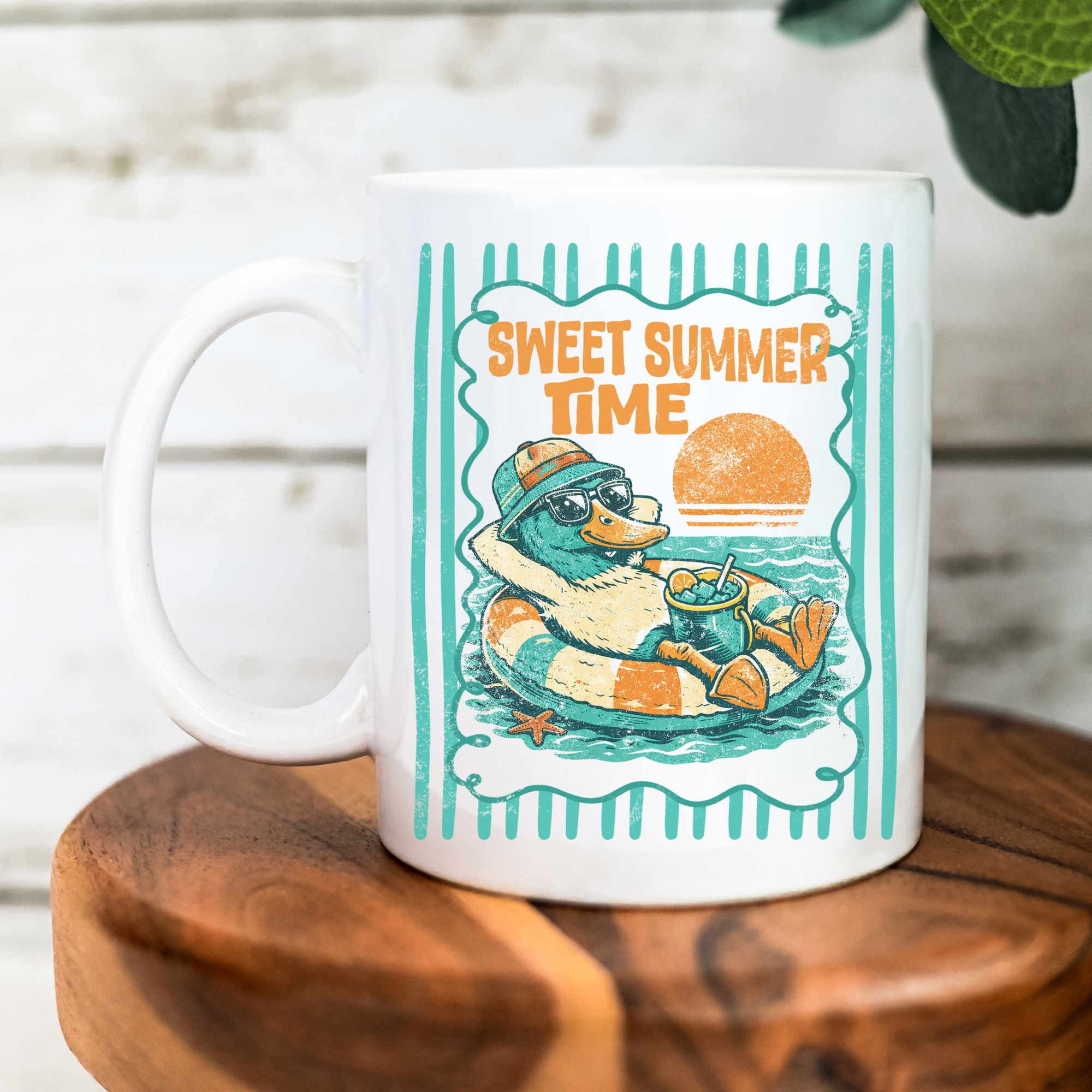 White mug with a duck graphic and 'Sweet Summer Time' text on a wooden surface.