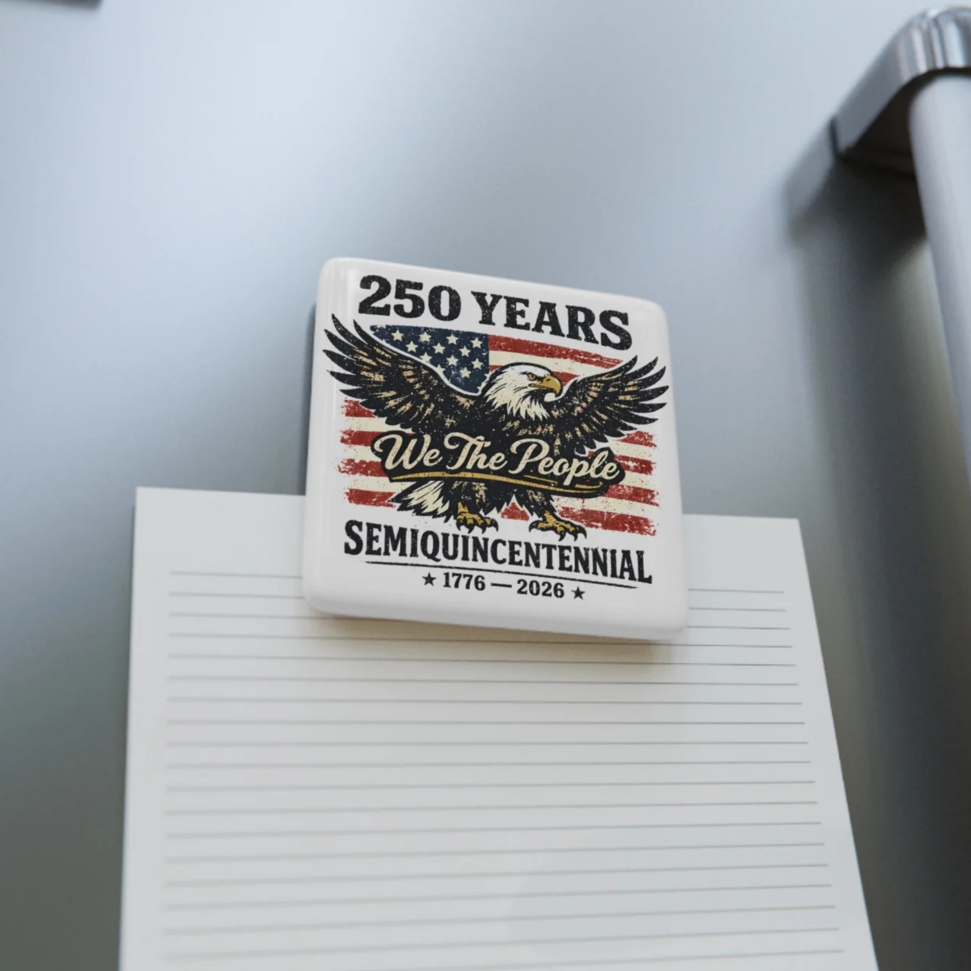 Small square magnet with an eagle and American flag design on a white surface