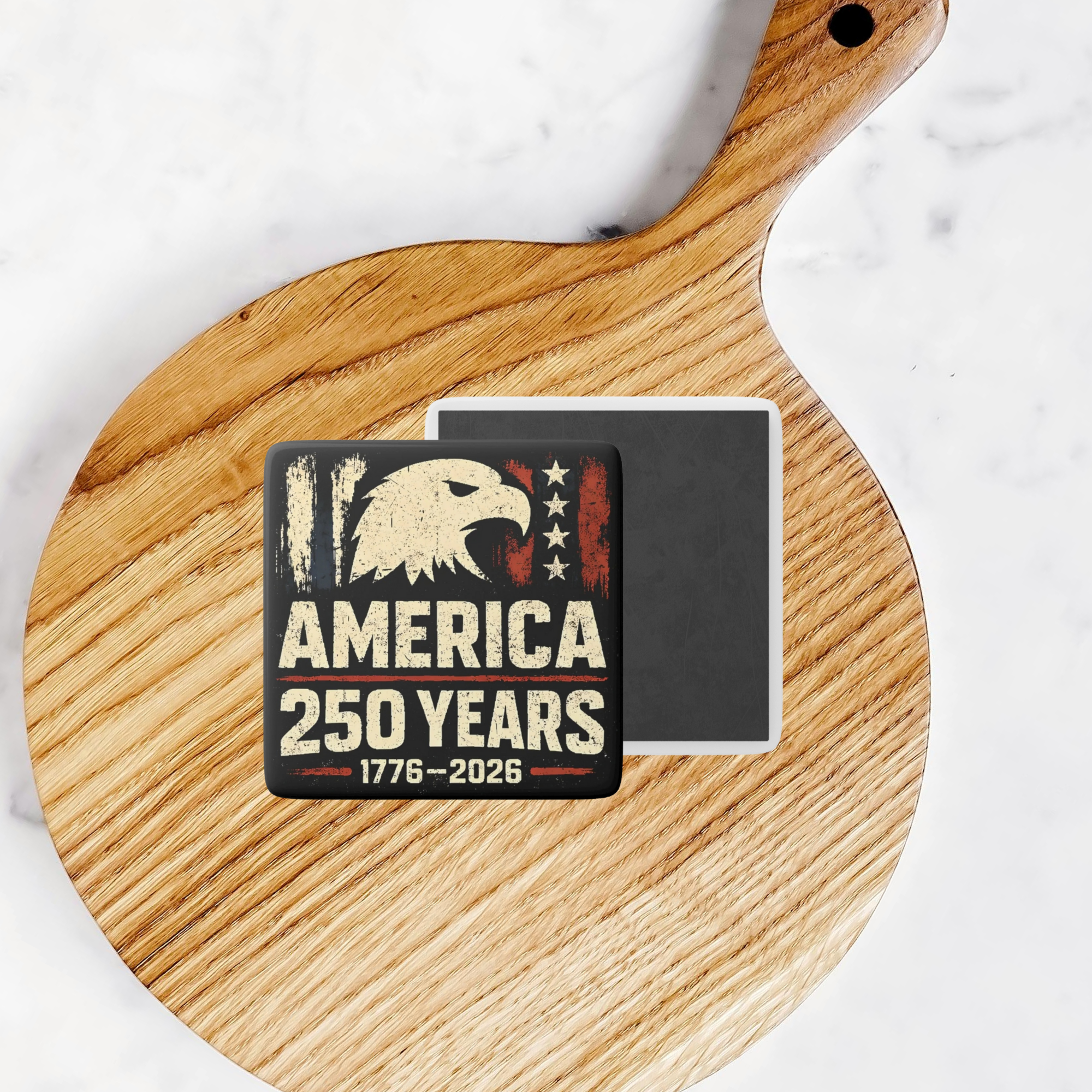 2 inch square magnet with Eagle design on a wooden surface