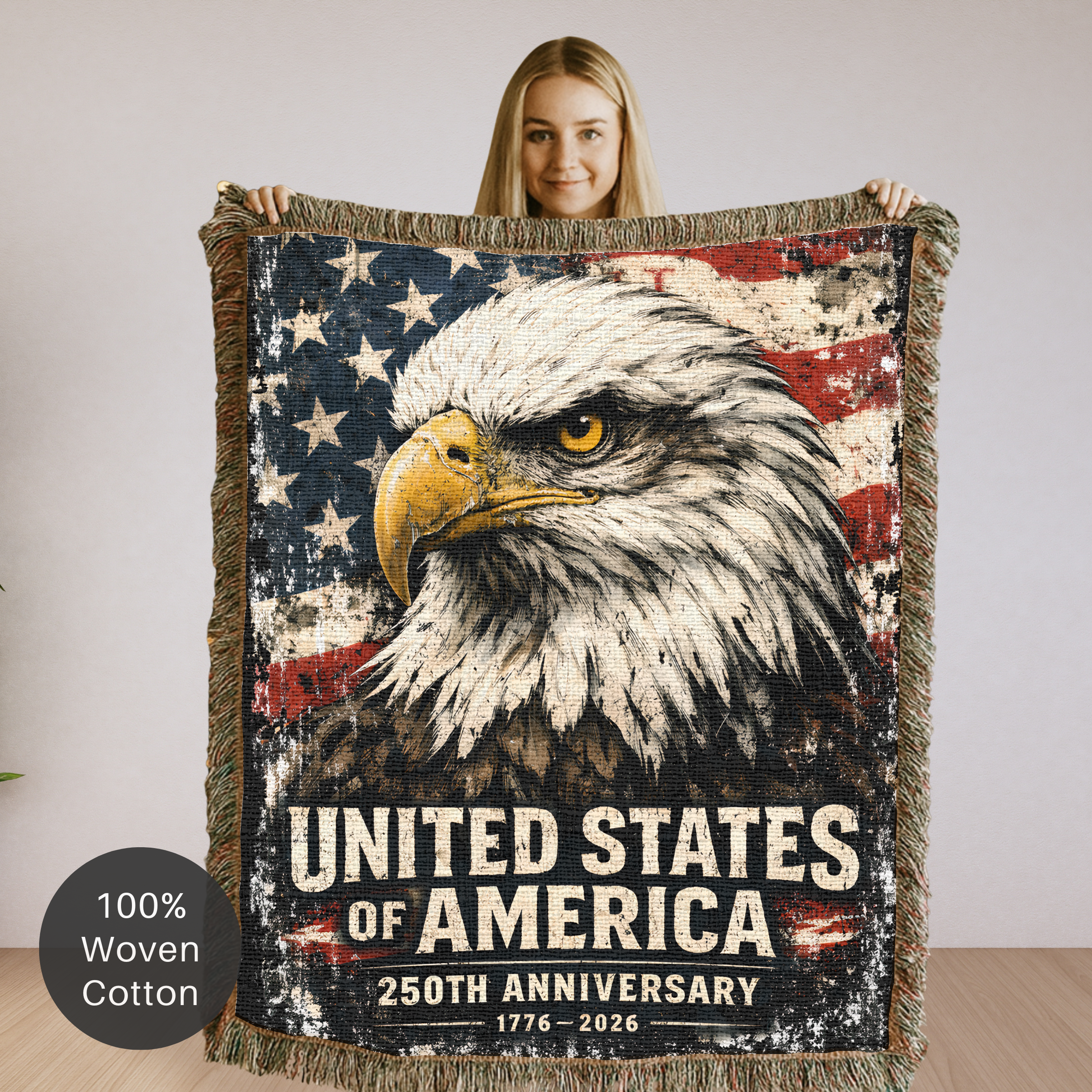 Person holding a woven blanket with an eagle and American flag design, featuring 'United States of America 250th Anniversary' text.
