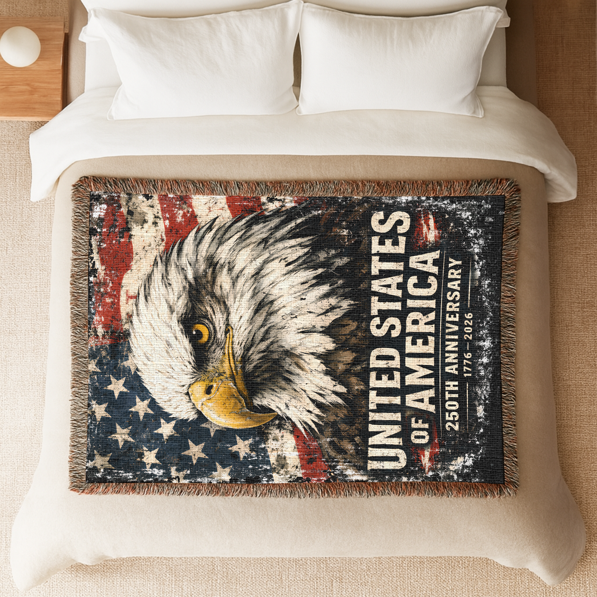 Woven blanket with an eagle design and 'United States of America' text laying on a bed