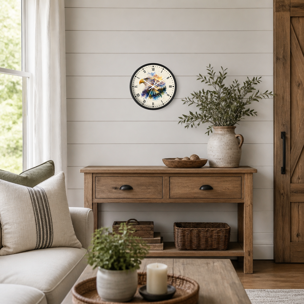 A round wall clock with a black frame and a rustic wood-and-stripe face hangs above a wooden console table in a styled living room. The scene includes a sofa, potted plants, baskets, and a vase with greenery.