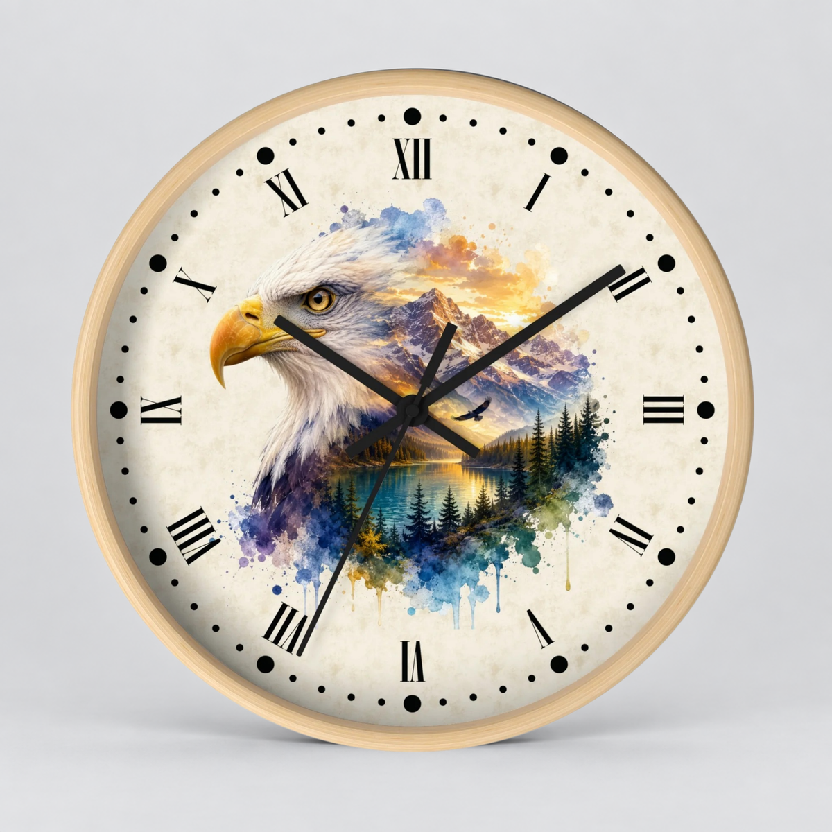 A round wall clock with a light wood frame and a cream-colored face, featuring a detailed illustration of a bald eagle over a mountain and lake landscape in blue, purple, yellow, and orange watercolor tones. The clock has black Roman numerals and black hands.