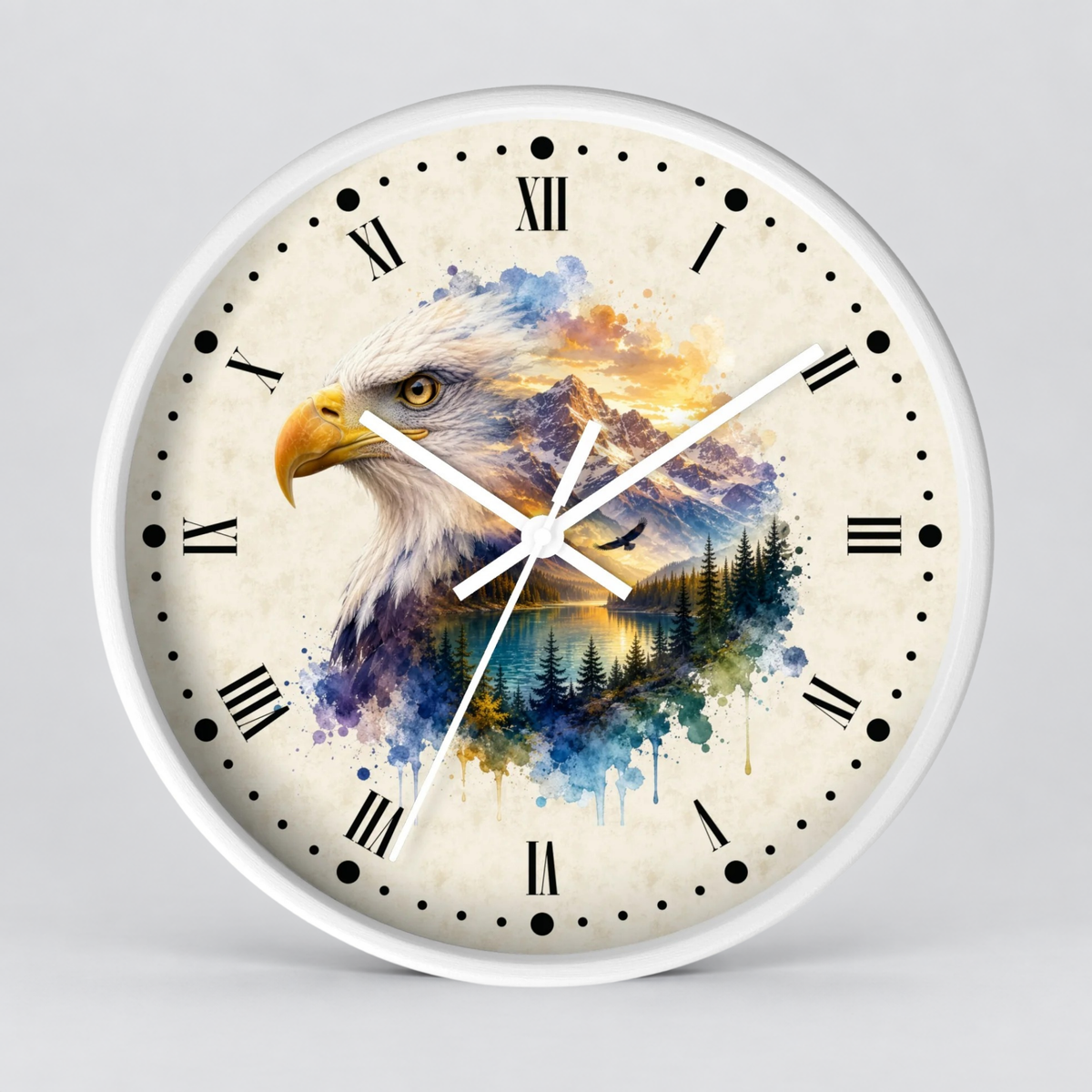 A round wall clock with a white frame and a cream-colored face featuring a watercolor-style bald eagle over a mountain and lake landscape. The clock has black Roman numerals and white hands against a light gray studio background.