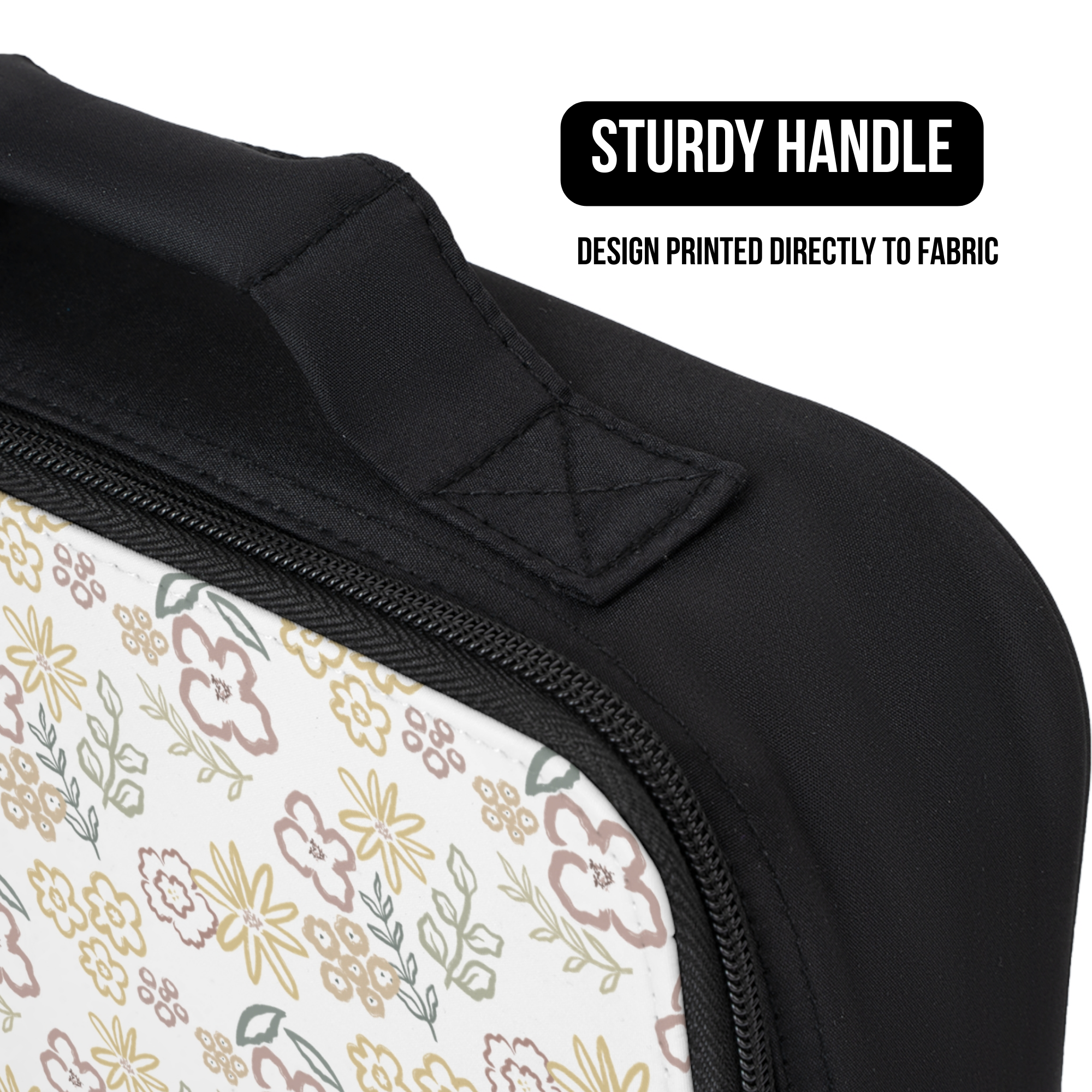 Close-up of a black lunch bag with a floral pattern and text highlighting a sturdy handle.