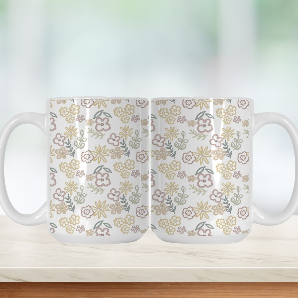 Two white mugs with floral pattern on a light background