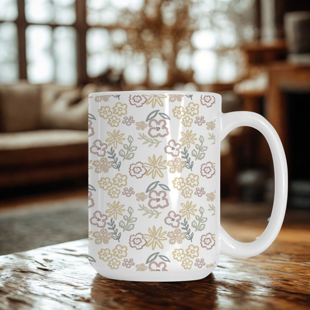 White mug with floral pattern on a wooden table in a cozy room.