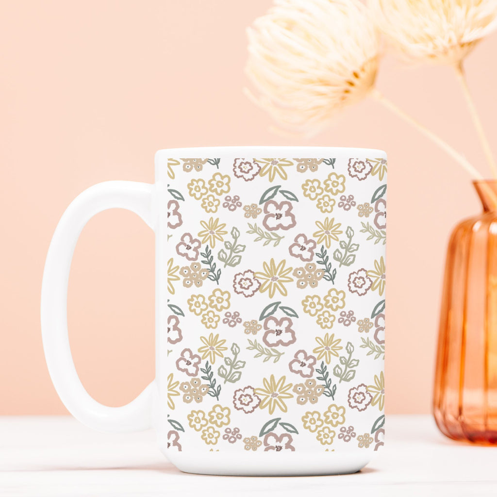 White mug with floral pattern on a light pink background