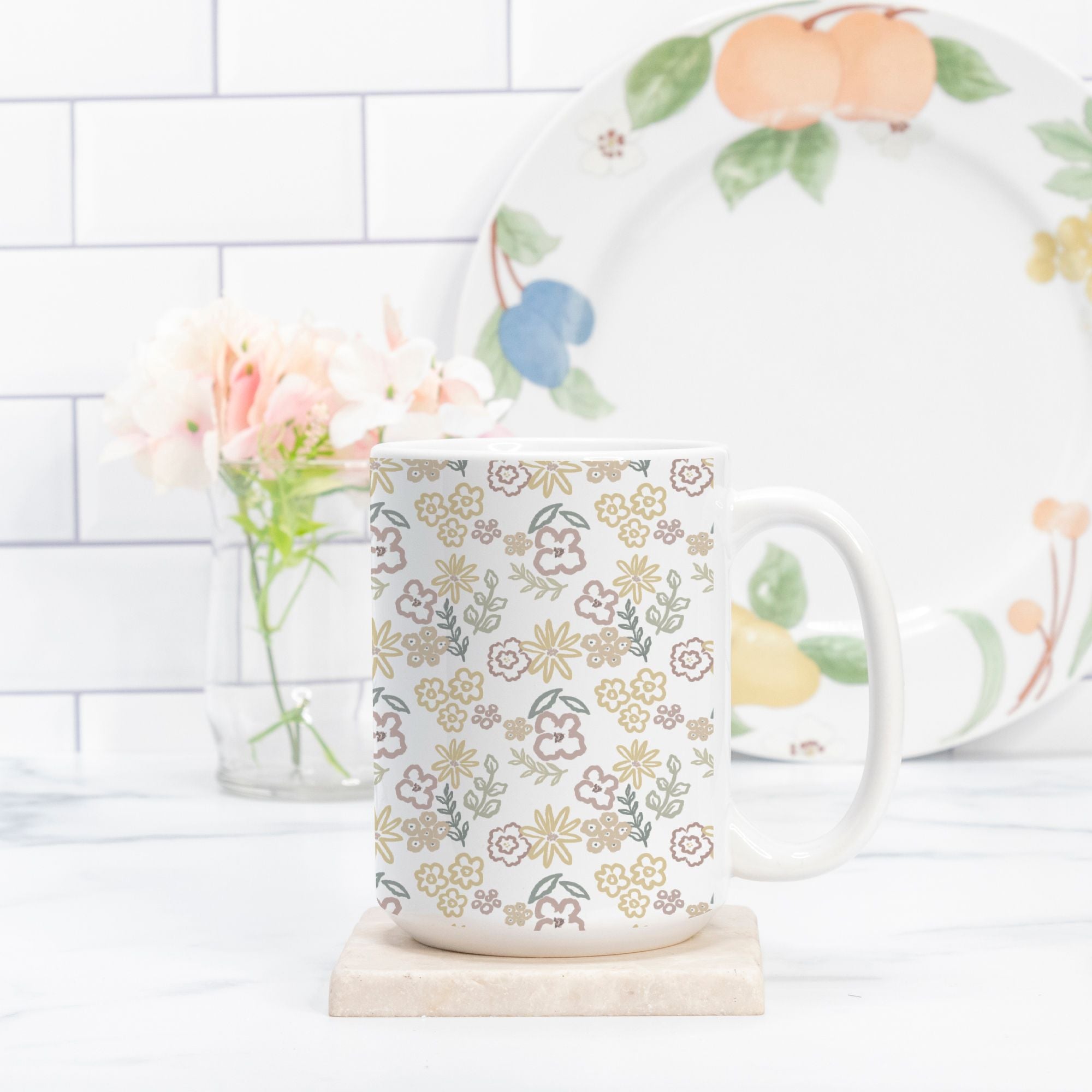 Floral-patterned mug and plate on a white surface with a light background
