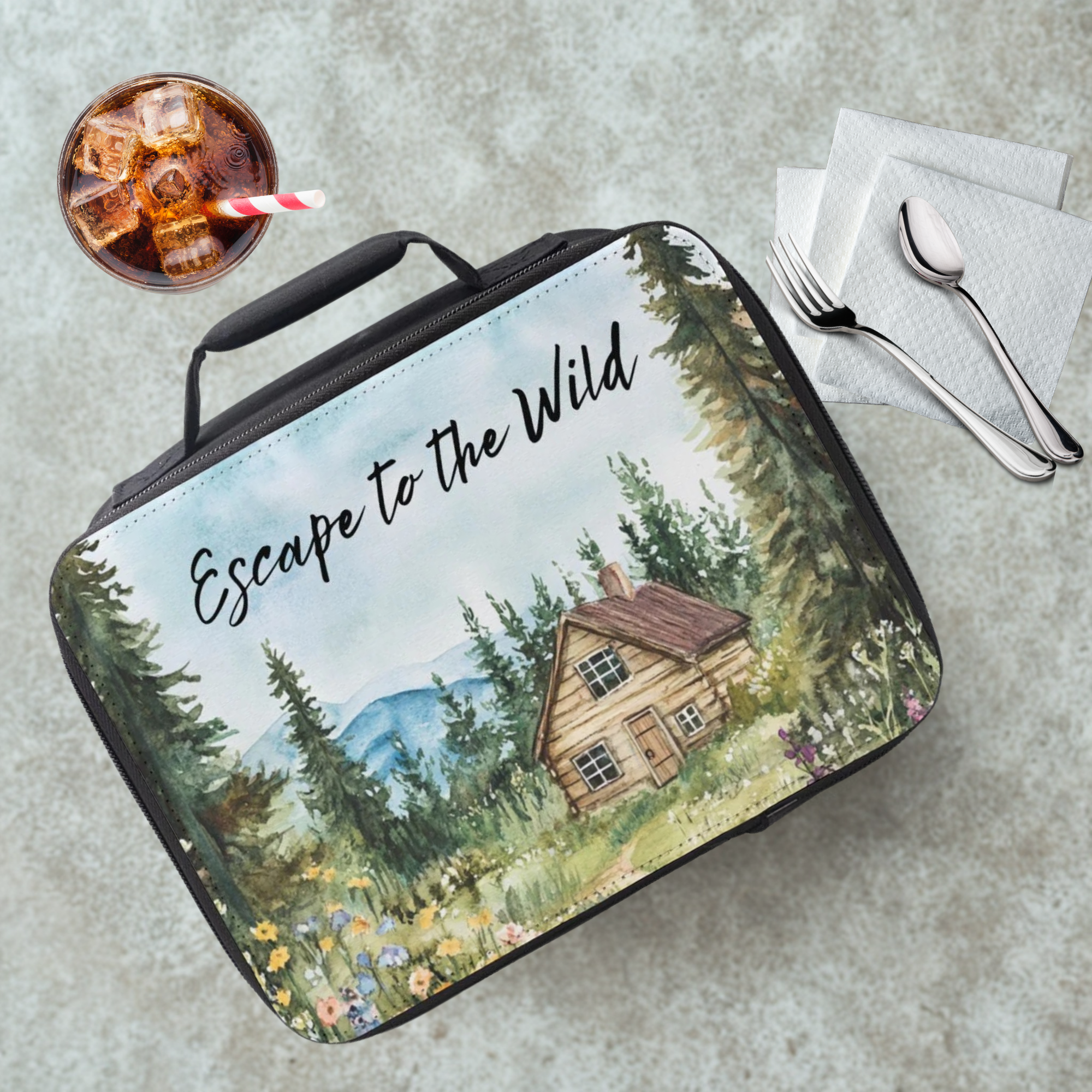 Lunch bag with nature design and 'Escape to the Wild' text on a cafeteria table with a drink and utensils.