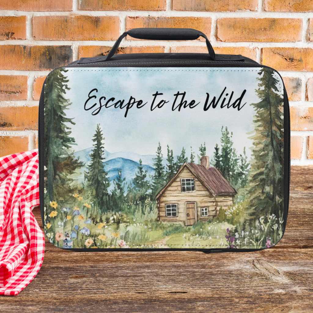  insulated lunch bag with nature-themed design and 'Escape to the Wild' text, placed on a wooden picnic table with a brick wall background.
