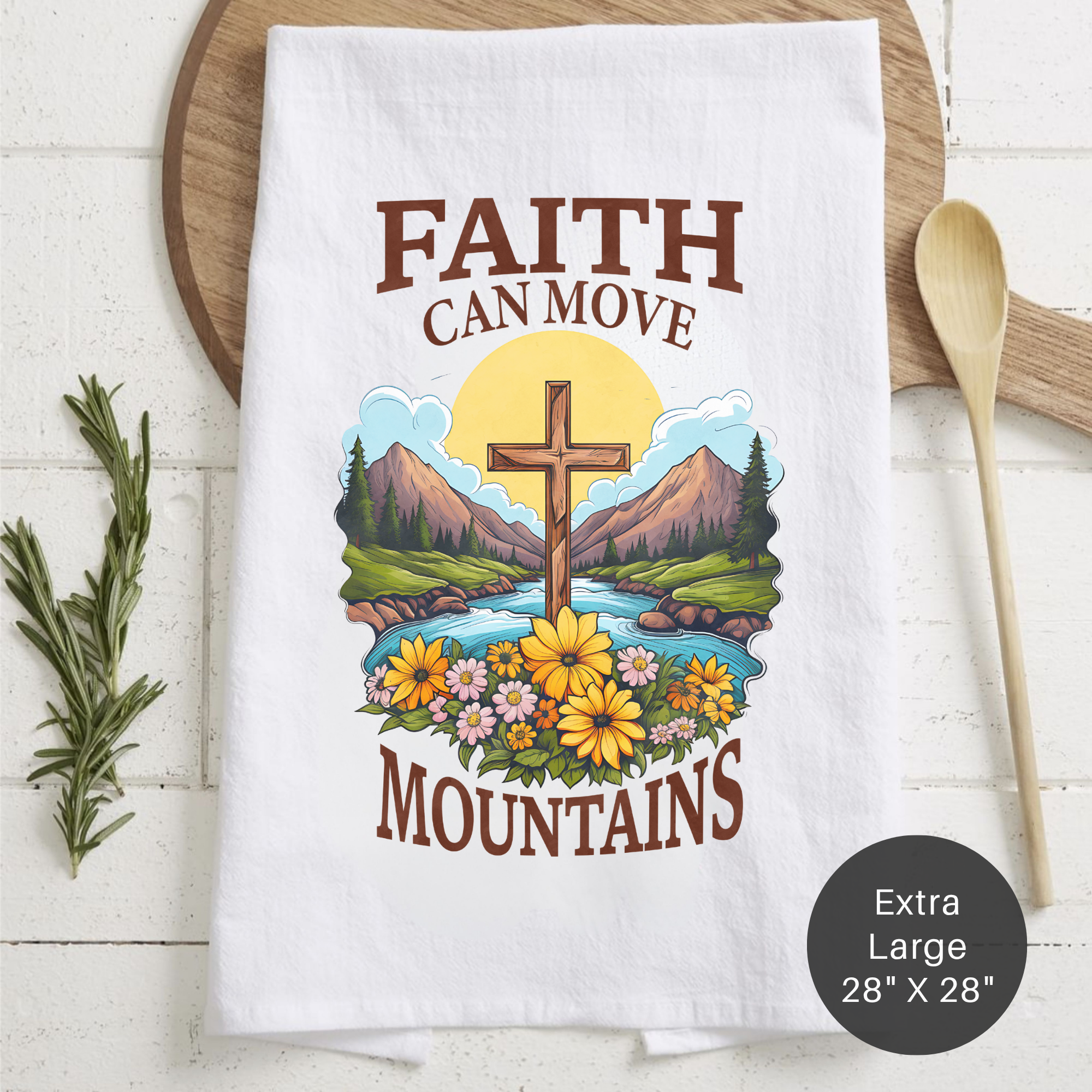 Tea towel with 'Faith Can Move Mountains' design on a wooden surface
